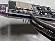 Use pliers to push the pins flush on the ESP32 side. This gets rid of any need to trim them short at the end, so that they don't puncture the heat-shrink wrapper.